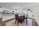 Kitchen and breakfast nook features granite countertops and white cabinets at 94 Shooting Star Ln, Clayton, NC 27520