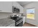 Bright kitchen with granite countertops, stainless steel oven, and white cabinets at 94 Shooting Star Ln, Clayton, NC 27520