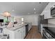 Well-lit kitchen featuring a large island, stainless steel appliances, and open layout at 94 Shooting Star Ln, Clayton, NC 27520