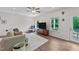 Cozy living room with wood floors, neutral decor, and a ceiling fan at 94 Shooting Star Ln, Clayton, NC 27520