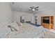 Spacious main bedroom featuring neutral carpet, ceiling fan, furniture, and a glimpse into ensuite bath at 94 Shooting Star Ln, Clayton, NC 27520