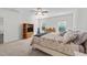 Spacious main bedroom with neutral carpet, ceiling fan, and two windows at 94 Shooting Star Ln, Clayton, NC 27520