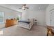 Bright main bedroom featuring neutral carpet, ceiling fan, and natural light from a window at 94 Shooting Star Ln, Clayton, NC 27520