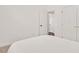 Bright bedroom shows lots of light from the hallway with neutral walls and carpet at 100 Bradborne Cir, Clayton, NC 27520