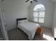 Bright bedroom features a large window, neutral paint and carpet, and vaulted ceilings at 100 Bradborne Cir, Clayton, NC 27520