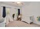 Charming bedroom with natural light, a crib, teepee, rocking chair and neutral colored carpet at 100 Bradborne Cir, Clayton, NC 27520
