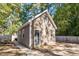 Exterior view of the home shows a detached garage, a picnic table and a large yard at 100 Bradborne Cir, Clayton, NC 27520