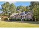 Charming home featuring a manicured lawn, brick accents, and a welcoming entrance at 100 Bradborne Cir, Clayton, NC 27520