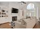 Cozy living room with fireplace, built-in bookshelves and an inviting sofa at 100 Bradborne Cir, Clayton, NC 27520