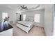 Bright main bedroom features a ceiling fan, large windows and sliding barn door for the en suite at 100 Bradborne Cir, Clayton, NC 27520