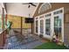 Relaxing outdoor patio features a TV, ceiling fan, outdoor furniture and privacy screen at 100 Bradborne Cir, Clayton, NC 27520
