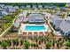 Aerial view of community showing pool, clubhouse, playground, and neatly arranged residential area at 104 Lingonberry Dr, Holly Springs, NC 27540