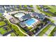 Aerial view of community featuring swimming pools, clubhouse, playground, and well-maintained landscaping at 104 Lingonberry Dr, Holly Springs, NC 27540