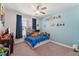 bedroom with cartoon wall decals, bright blue paint, and a ceiling fan at 104 Lingonberry Dr, Holly Springs, NC 27540