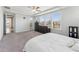 Bright bedroom with large windows, a ceiling fan, and access to the outdoors through a glass door at 104 Lingonberry Dr, Holly Springs, NC 27540