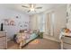 Bedroom with cartoon decals, a ceiling fan, and a bright colorful rug at 104 Lingonberry Dr, Holly Springs, NC 27540