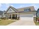 Charming single-Gathering home with a two-car garage and welcoming front porch at 104 Lingonberry Dr, Holly Springs, NC 27540