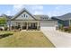 Well-maintained home with a two-car garage, covered entry and a beautifully landscaped front yard at 104 Lingonberry Dr, Holly Springs, NC 27540