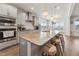 Contemporary kitchen with a large island, granite countertops, stainless steel appliances and barstool seating at 104 Lingonberry Dr, Holly Springs, NC 27540