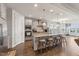 Modern kitchen featuring a large island with seating, stainless steel appliances and pendant lighting at 104 Lingonberry Dr, Holly Springs, NC 27540