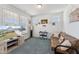 Cozy living room with a futon, TV, and lots of light from the windows at 104 Lingonberry Dr, Holly Springs, NC 27540