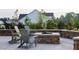 Outdoor patio with stone firepit and comfortable seating, ideal for relaxing evenings at 104 Lingonberry Dr, Holly Springs, NC 27540