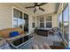 Relaxing screened-in patio with comfortable wicker furniture, ceiling fan, and sliding glass doors at 104 Lingonberry Dr, Holly Springs, NC 27540