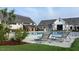 Inviting poolside scene with lounge chairs, lush grass, and community buildings in the background at 104 Lingonberry Dr, Holly Springs, NC 27540