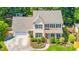 Aerial view of a two-story home with a manicured lawn, driveway, and convenient attached garage at 104 Ludstone Ct, Cary, NC 27513