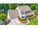 Aerial view of a spacious home with a large garage and a meticulously landscaped front yard at 104 Ludstone Ct, Cary, NC 27513
