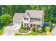 Aerial view of a two-story home with a well-maintained yard and a convenient attached garage at 104 Ludstone Ct, Cary, NC 27513