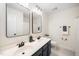 Well-lit bathroom features a double vanity with mirrors and modern fixtures at 104 Ludstone Ct, Cary, NC 27513