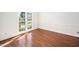Empty room with lots of natural light and hardwood floors at 104 Ludstone Ct, Cary, NC 27513