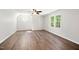 Bonus room with hardwood floors, ceiling fan, and large window at 104 Ludstone Ct, Cary, NC 27513