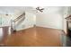 Open-concept living room with hardwood floors, staircase, and easy access to the front door, perfect for entertaining at 104 Ludstone Ct, Cary, NC 27513