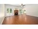 Light-filled living room with hardwood floors, wood burning fireplace, and large windows offering serene views at 104 Ludstone Ct, Cary, NC 27513
