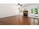 Spacious living room with hardwood floors, fireplace, and plenty of natural light, perfect for Gathering gatherings at 104 Ludstone Ct, Cary, NC 27513