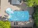 Aerial view of the pool with a diving board and lounge chairs at 10825 Rondeau Woods Ct, Raleigh, NC 27614