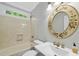 Bathroom with decorative mirror, shower and tile surround at 10825 Rondeau Woods Ct, Raleigh, NC 27614