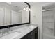 Bathroom featuring double sinks, a marble countertop, and a walk-in shower at 10825 Rondeau Woods Ct, Raleigh, NC 27614