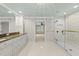 Spacious bathroom with a glass walk-in shower, double sinks, and white cabinetry at 10825 Rondeau Woods Ct, Raleigh, NC 27614