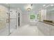 Spacious bathroom featuring a soaking tub, walk-in shower, and double vanity at 10825 Rondeau Woods Ct, Raleigh, NC 27614