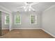Bright bedroom with natural light, neutral paint, and carpet flooring at 10825 Rondeau Woods Ct, Raleigh, NC 27614