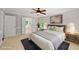 Comfortable bedroom featuring a ceiling fan, ensuite bathroom, and soft, natural light at 10825 Rondeau Woods Ct, Raleigh, NC 27614