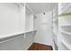 Walk-in closet featuring custom shelves and wood floors at 10825 Rondeau Woods Ct, Raleigh, NC 27614