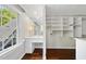 Spacious closet featuring natural light, custom shelving, and wood floors at 10825 Rondeau Woods Ct, Raleigh, NC 27614