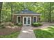Charming brick guest house with a brick walkway surrounded by lush landscaping at 10825 Rondeau Woods Ct, Raleigh, NC 27614