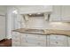 Bright kitchen features granite counters, tiled backsplash and custom white cabinetry at 10825 Rondeau Woods Ct, Raleigh, NC 27614