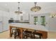 Kitchen with an island, updated appliances, granite countertops, and unique pendant lighting at 10825 Rondeau Woods Ct, Raleigh, NC 27614