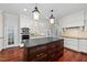 Spacious kitchen with stainless steel appliances, large island, and hardwood floors at 10825 Rondeau Woods Ct, Raleigh, NC 27614